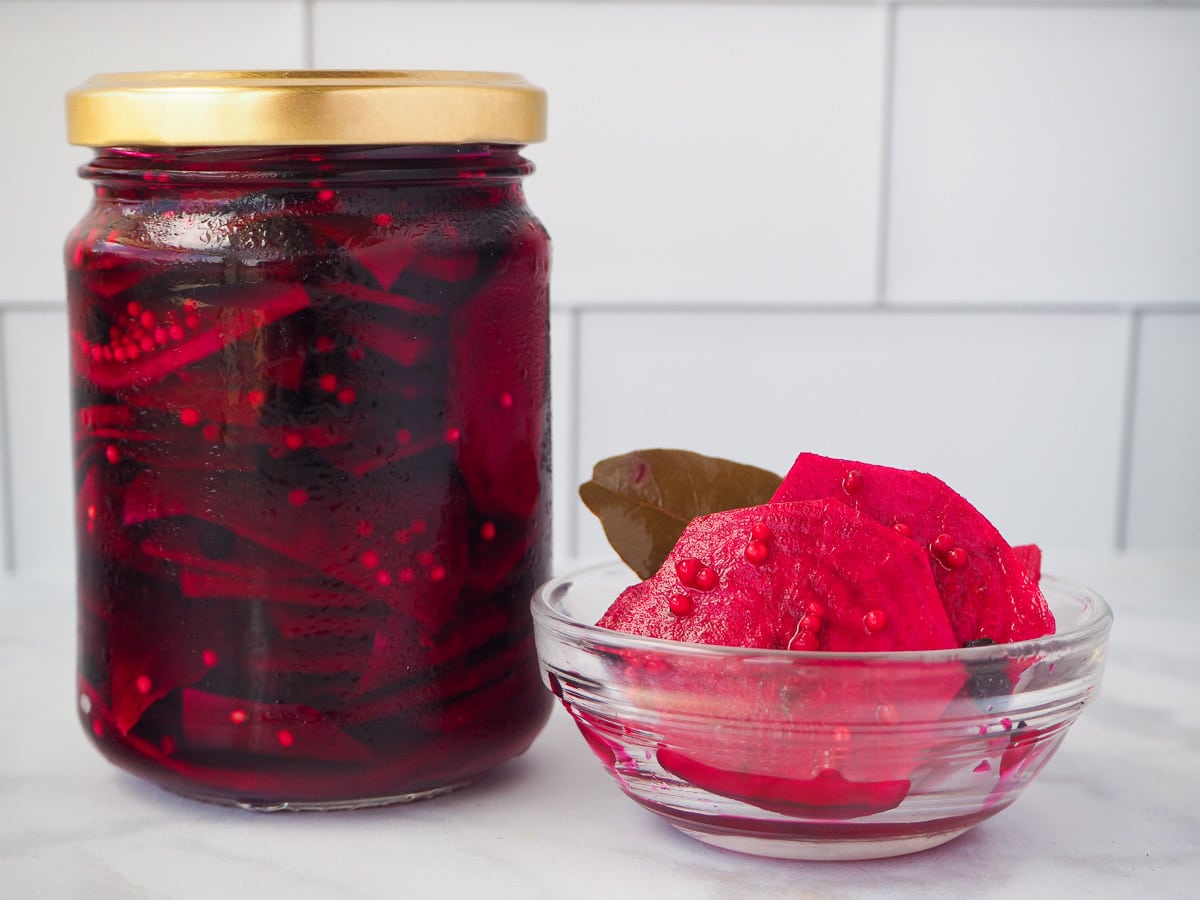Jar of pickled beets with small glass bowl refrigerator pickled beets
