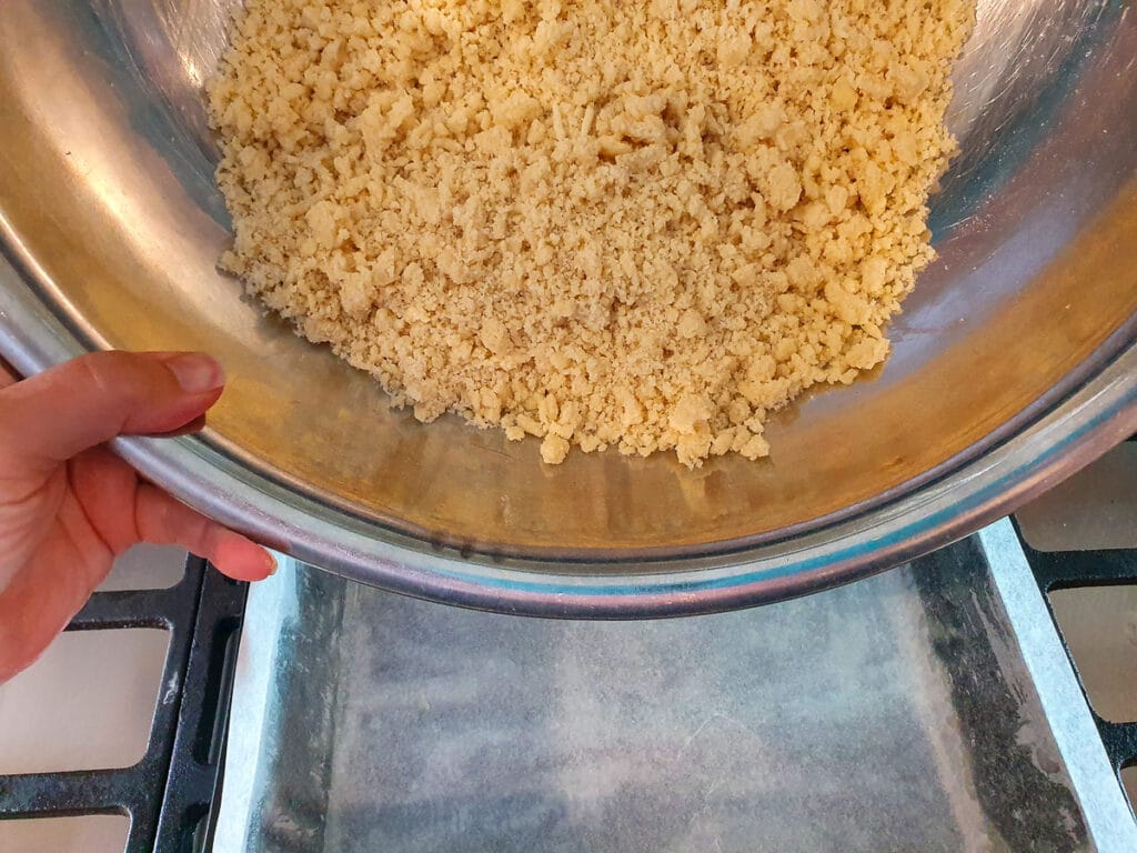 Adding base to lined baking tin.