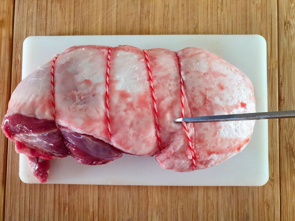 Cutting the string off the lamb.