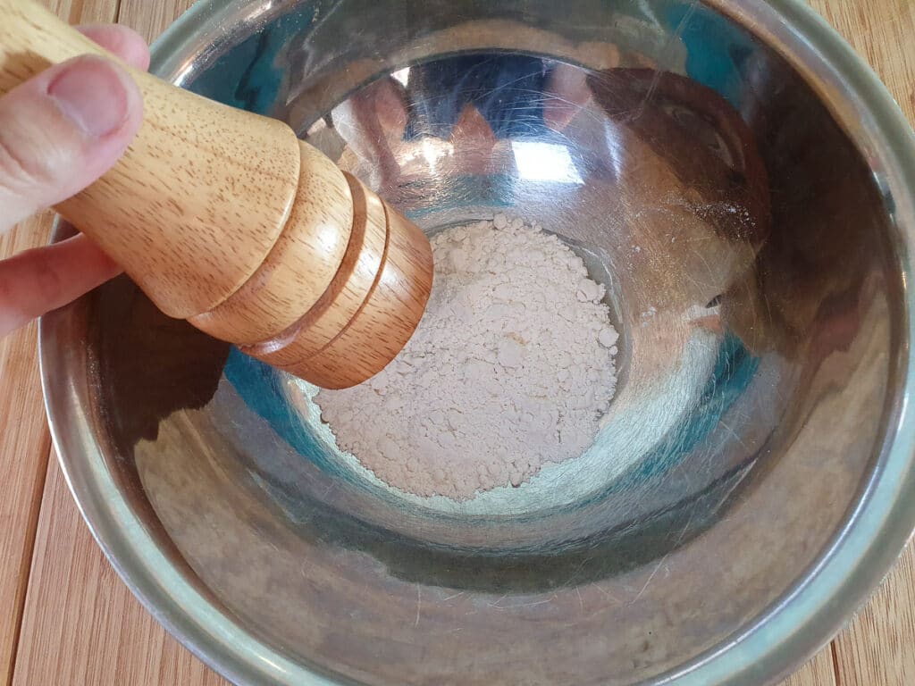 Seasoning the flour.