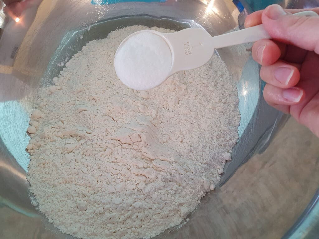 Adding the baking powder to the flour.