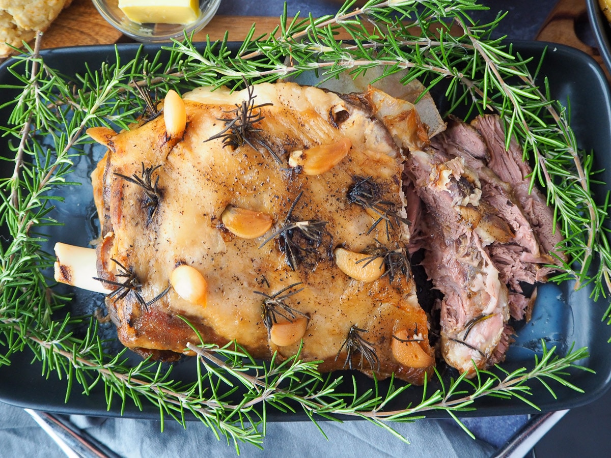 Slow cooker lamb roast on a serving plate.