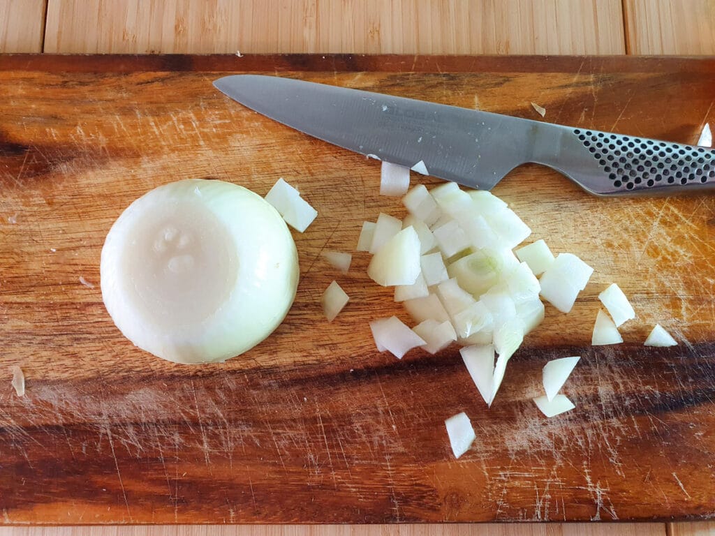 Peeling and dicing brown onions.
