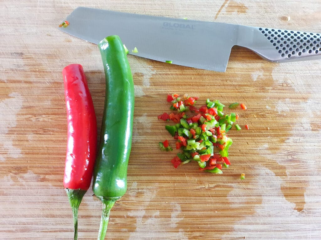 Chopping up the red and green chilli.