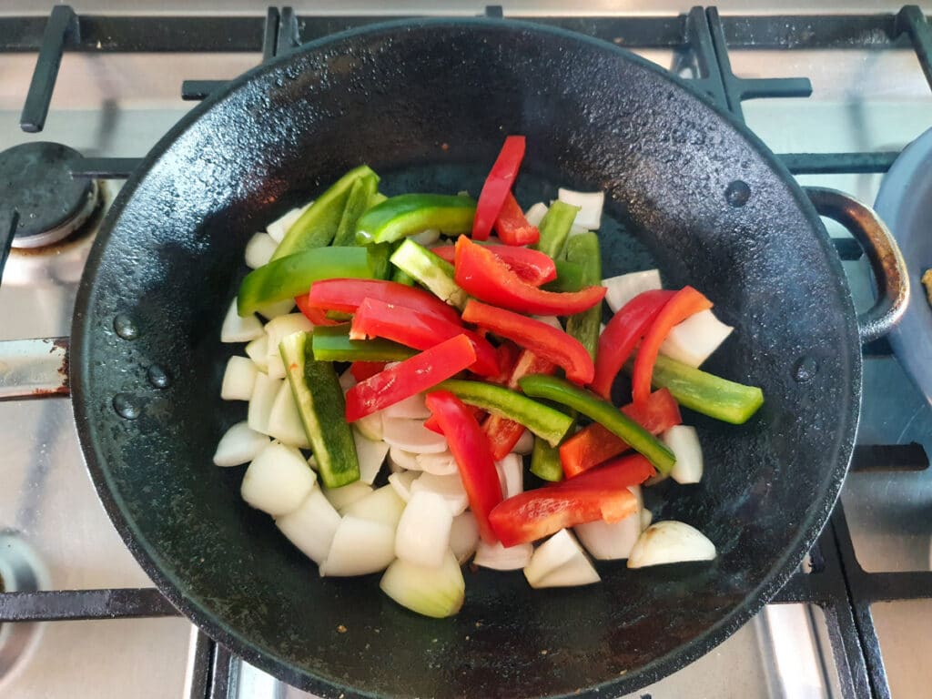 Pan frying capsicum and onion.