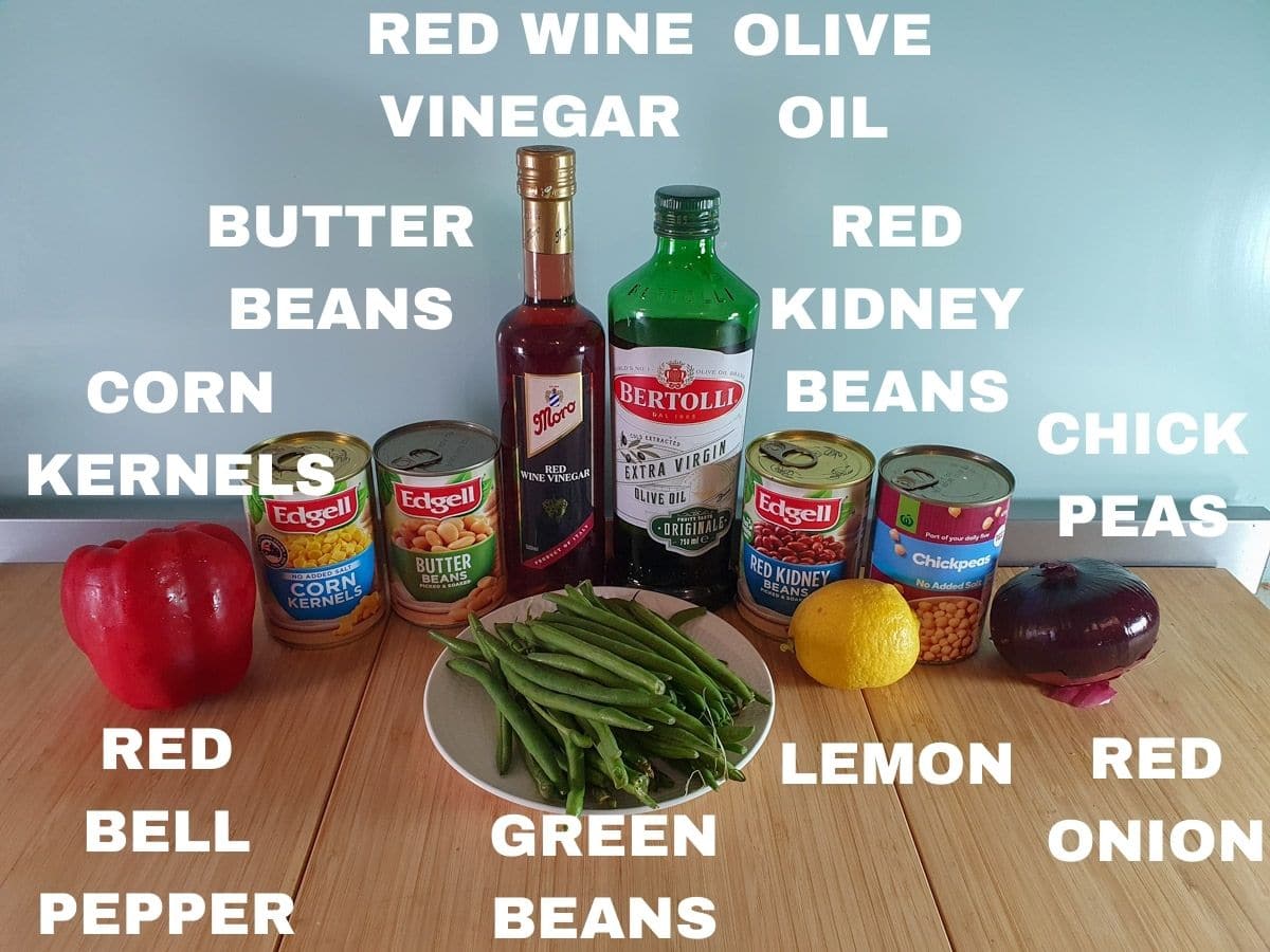 Bean salad ingredients, red bell pepper, tin corn kernels, tin butter beans, fresh green beans, red wine vinegar, olive oil, tin red kidney beans, tin chickpeas, fresh lemon, red onion.,