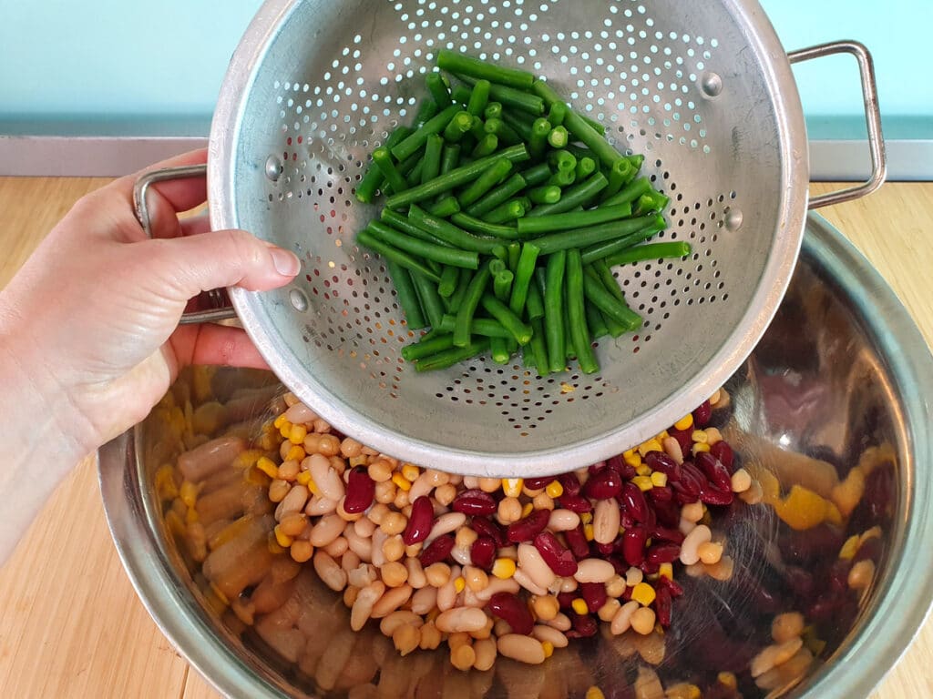 Adding cooked green beans.