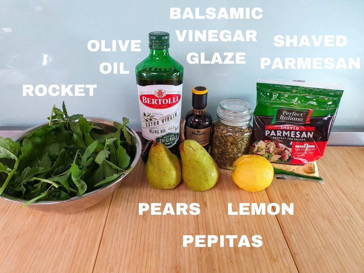 Salad ingredients, rocket, olive oil, pears, balsamic vinegar glaze, pepitas, shaved parmesan, lemon.