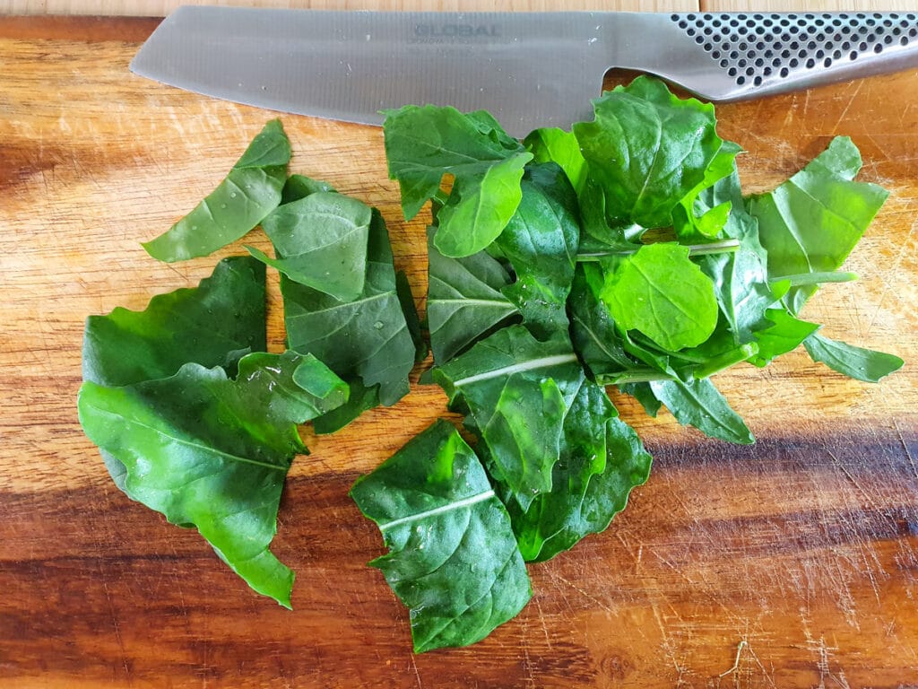 Roughly chopping rocket leaves.