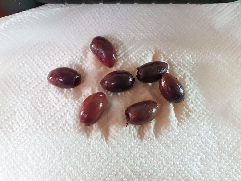 Patting dry Kalamata olives.